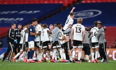The Fulham players celebrate victory and promotion to the Premier League.