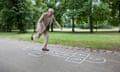 Senior man playing hopscotch in the park