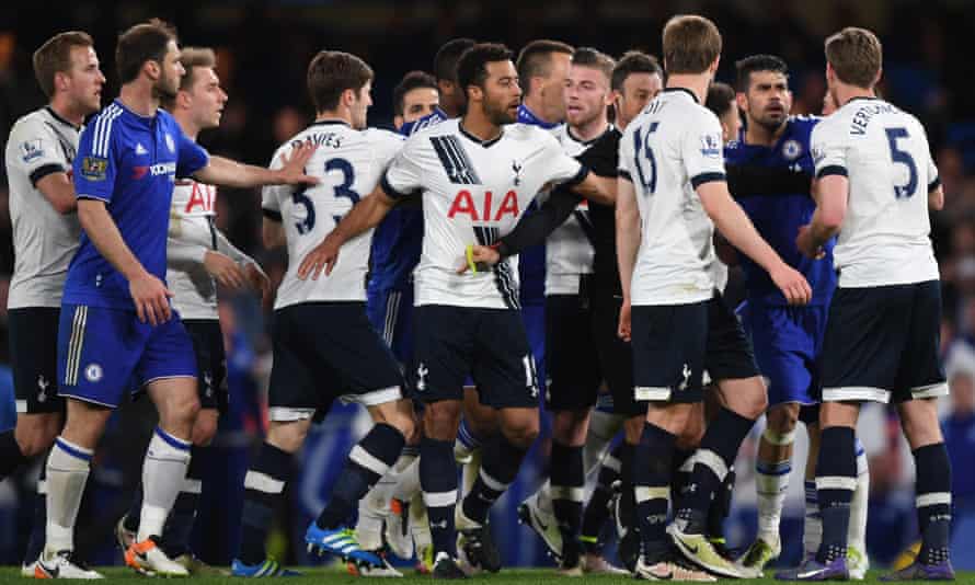 Mark Clattenburg, fifth from right, tries to keep the Tottenham and Chelsea players apart during a tempestuous game.