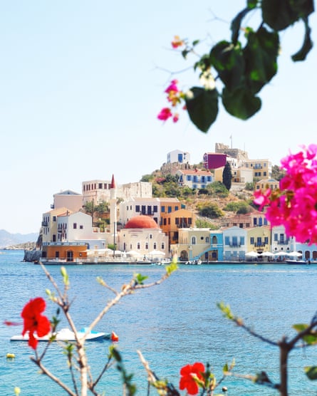 Adding summer flowers in the foreground may help you create a unique photograph. Get closer to the flowers or trees to frame your photo as I did in this shot on Kastellorizo Island in Greece, less than a mile from the Turkish coast.