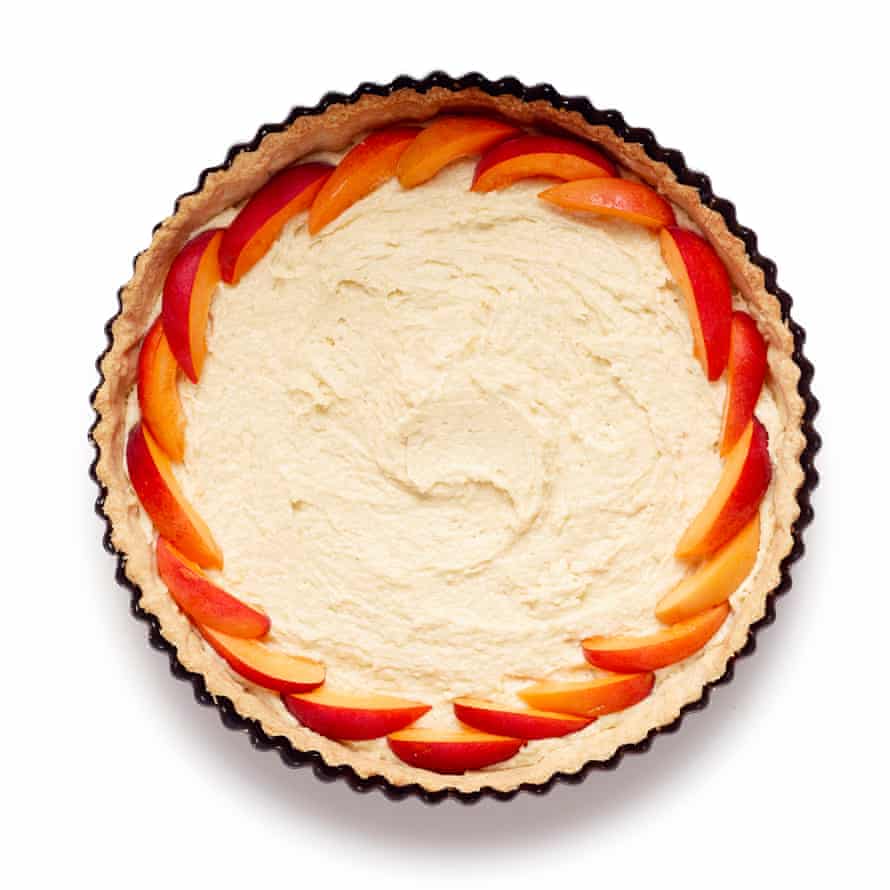 Felicity Cloake’s apricot tart step 7: spread frangipane on the pastry base and then start to add the fruit.