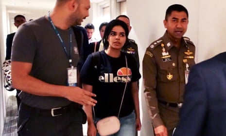 Rahaf Mohammed al-Qunun is escorted by Thai and UNHCR officials at the Suvarnabhumi international airport in Bangkok on Monday.