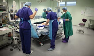 Operating theatre staff care for a patient