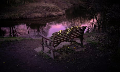 Yellow ribbons and daffodils adorn the bench where the phone of missing Nicola Bulley was found, on the banks of the River Wyre.