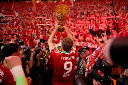 Harry Kane hoists the DFB Cup aloft in May after Bayern’s win over Stuttgart