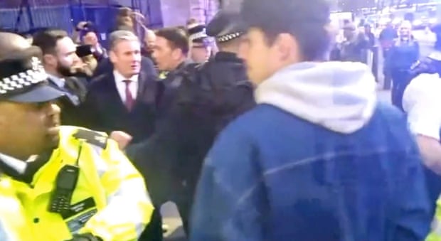 Keir Starmer escorted to a police car after being heckled by protesters.