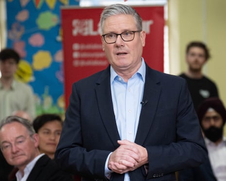 Keir Starmer speaking to Labour members in a small hall