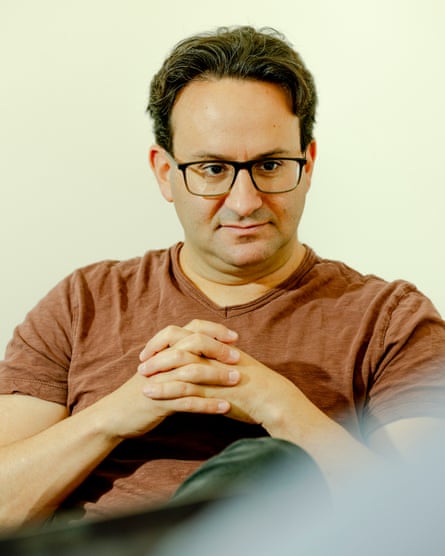 Kaplan looks down with folded hands