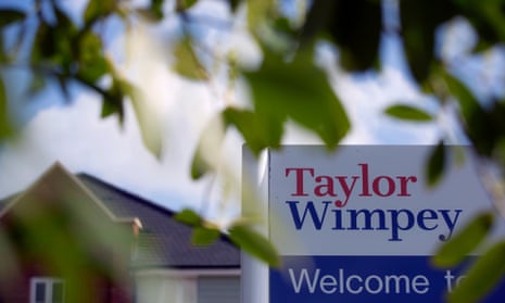 A sign outside newly constructed homes at a Taylor Wimpey construction site