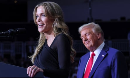 Megyn Kelly standing at a podium in front of a smiling Donald Trump