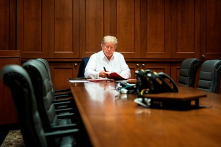 White House handout photo shows Donald Trump working in his conference room at Walter Reed on 3 October.