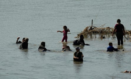 People cool themselves in the waters of the Rio Grande after crossing to the US from Mexico.