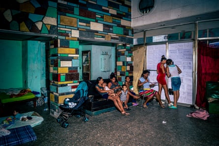Women stand guard with their children at recently occupied offices in Old Havana