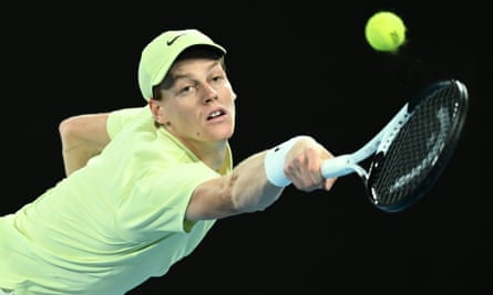 Jannik Sinner stretches to hit a shot