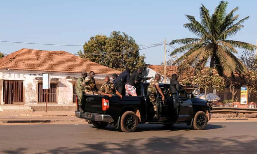 Soldiers move on the main artery of the capital after heavy gunfire around the presidential palace in Bissau, Guinea-Bissau