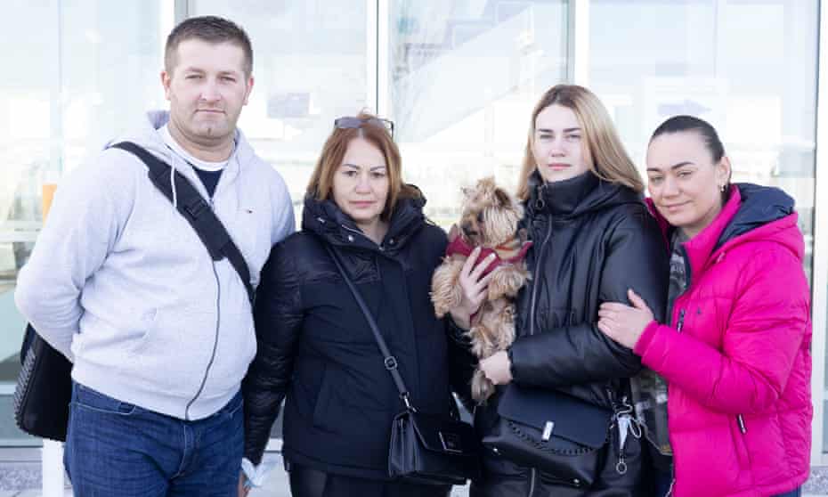 Krzysztof Mikucki with his Ukrainian family and dog