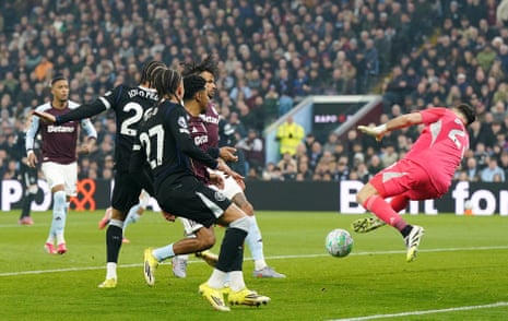 Aston Villa goalkeeper Emiliano Martinez (right) saves a header on goal from Chelsea's Joao Pedro.