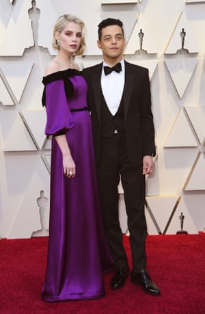Rami Malek is nominated for his role as Freddie Mercury in Bohemian Rhapsody, for which he wore everything from kimonos to leather trousers but kept it simple for the Oscars red carpet in a classic tuxedo by Saint Laurent. His co-star Lucy Boynton, meanwhile, had a Rodarte dress in the colour of Cadbury's purple