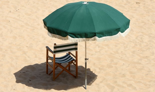 An empty deckchair and parasol stand on the sands of Saint-Jean de Luz beach, south-western France, on June 18, 2022