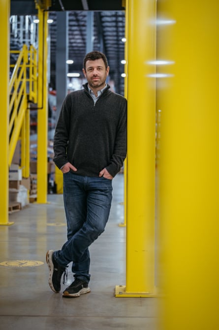 Man standing for a portrait between large yellow metal polls