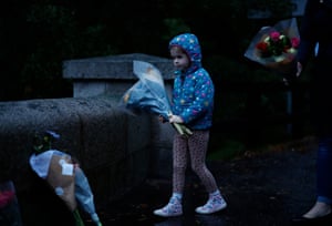 A young girl leaves flowers outside Balmoral Castle