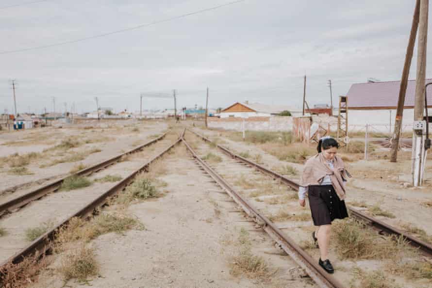 woman walking along tracks