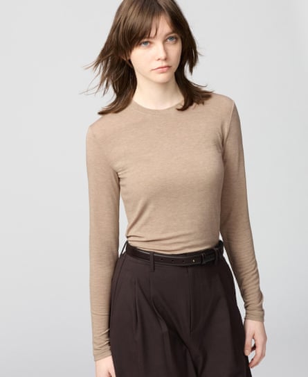 woman wearing beige shirt and dark brown trousers