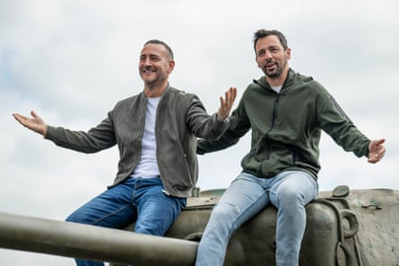 Will Mellor and Ralf Little sittong on the turret of a tank.