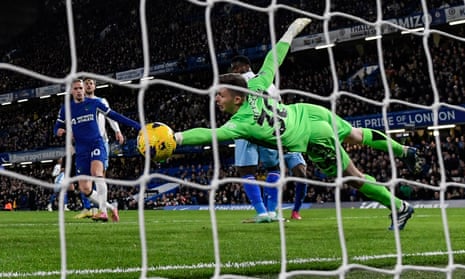 Chelsea's Mykhailo Mudryk (left) shoots and scores his team first goal past Crystal Palace's keeper Dean Henderson.
