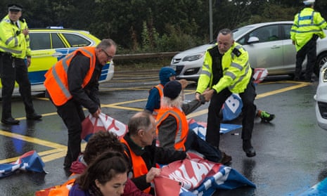 Police remove Insulate Britain protestors who were blocking a major roundabout near Heathrow airport in September.