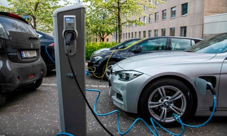 Electric cars are charged on a street in Oslo, Norway.