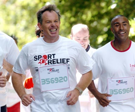 A grinning Tony Blair running in a white Sport Relief T-shirt
