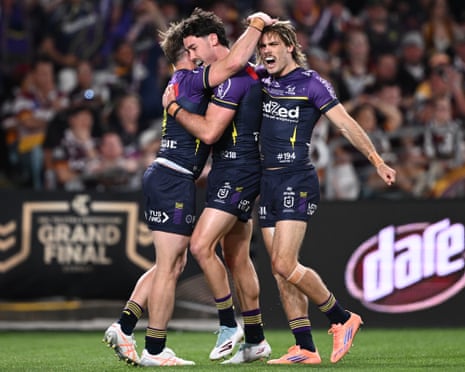 Nick Meaney and the Melbourne Storm celebrate scoring a try during the NRL grand final