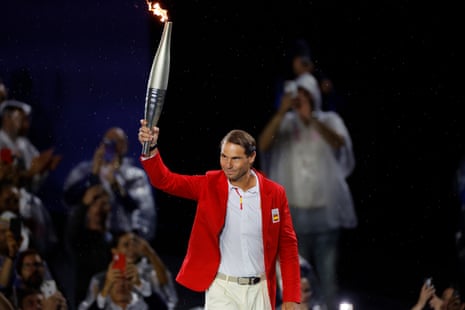 Rafael Nadal carries the Olympic torch.