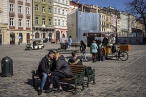 A couple kisses on a bench in downtown Lviv, western Ukraine