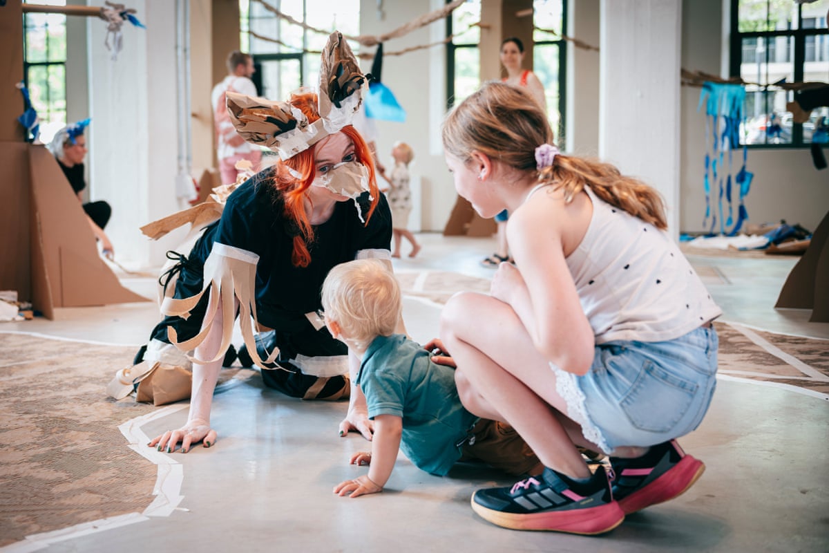 A Polyglot Theatre actor in animal costume performs for children