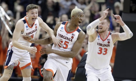 Virginia’s Mamadi Diakite, center, reacts with teammates Kyle Guy and Jack Salt after hitting a shot to send their game into overtime