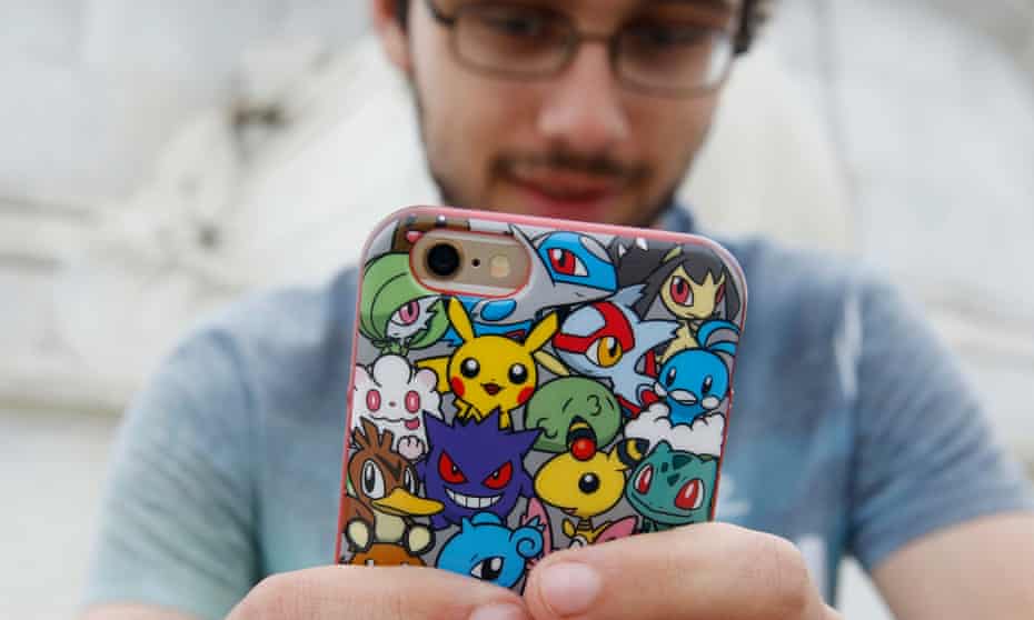 A player’s phone is decorated with Pokemon stickers as he plays Pokemon Go in London on Saturday.