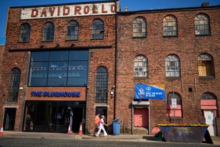 Fans and onlookers passing the former David Rollo & Sons building, now housing The Bluehouse, one of the new bars opened opposite around Everton’s new Hill Dickinson stadium