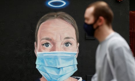 Coronavirus mural in Manchester showing a nurse wearing a mask under a halo