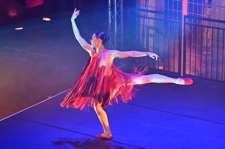 A dancer in swingy red dress in Proms and the ENO at Printworks, London.