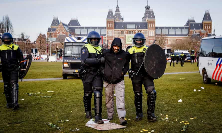 Police detains a protester on the Museumplein at Museumplein, Amsterdam, Netherlands, 31 January 2021.