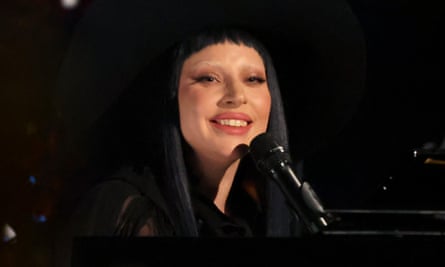 a woman smiles before a microphone on stage