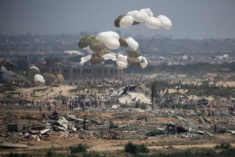 Aid pallets are parachuted after being dropped from a military plane over Nuseirat in the central Gaza Strip during an airdrop mission above the Israel-besieged Palestinian territory on 18August 2025.