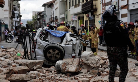 A car crushed by debris after an earthquake shook Cuenca, Ecuador
