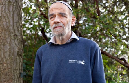 Rabbi Jonathan Wittenberg in his garden wearing a blue jumper