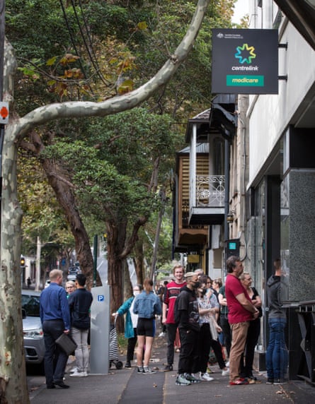People queue along Crown Street in Sydney’s Darlinghurst on Monday to get into the Centrelink offices.