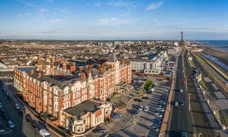 Aerial view of Blackpool, UK, with the Imperial Hotel in the foreground and Blackpool tower in the background, on a blue-sky day, with the tide out.