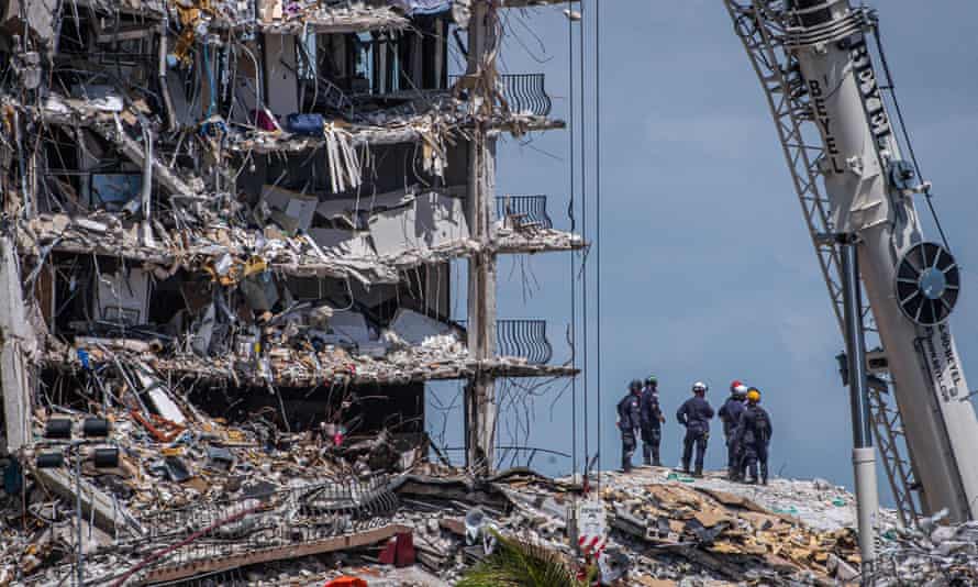 Members of the South Florida Urban Search and Rescue team look for survivors in the partially collapsed 12-story Champlain Towers.