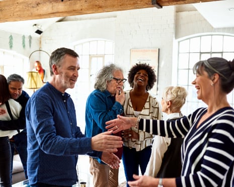 Mature friends greeting each other at social gathering